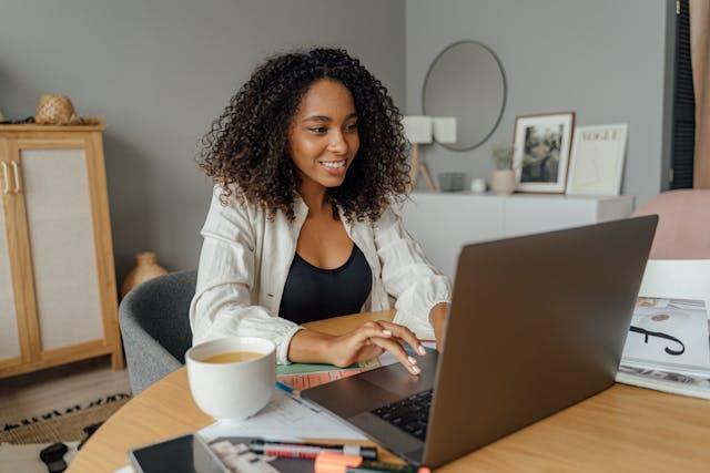 A woman using her laptop and smiling