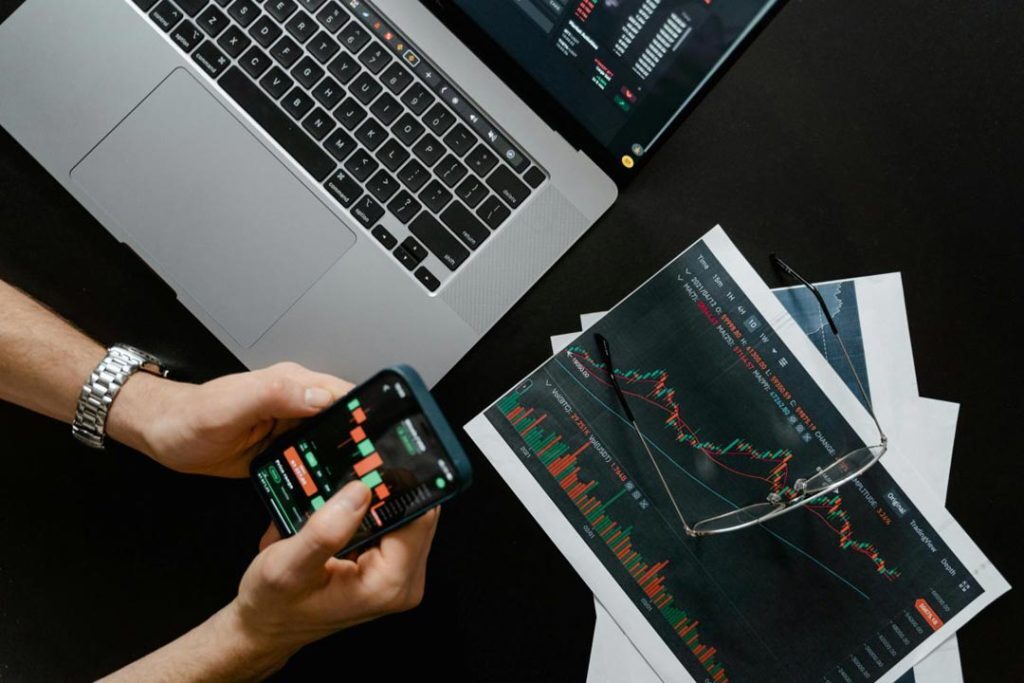 trading on phone and laptop